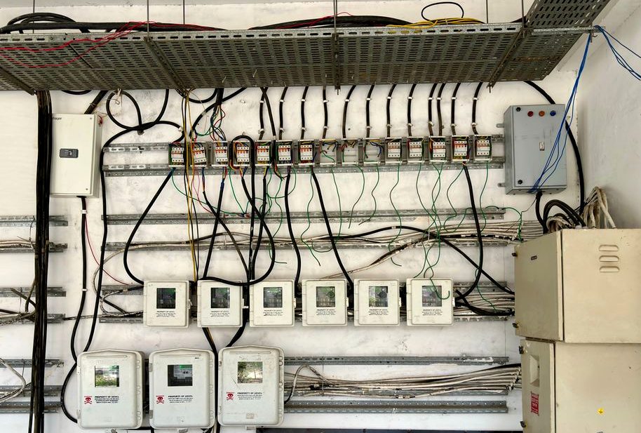 Complex network of electrical wiring and control panels in an industrial setting